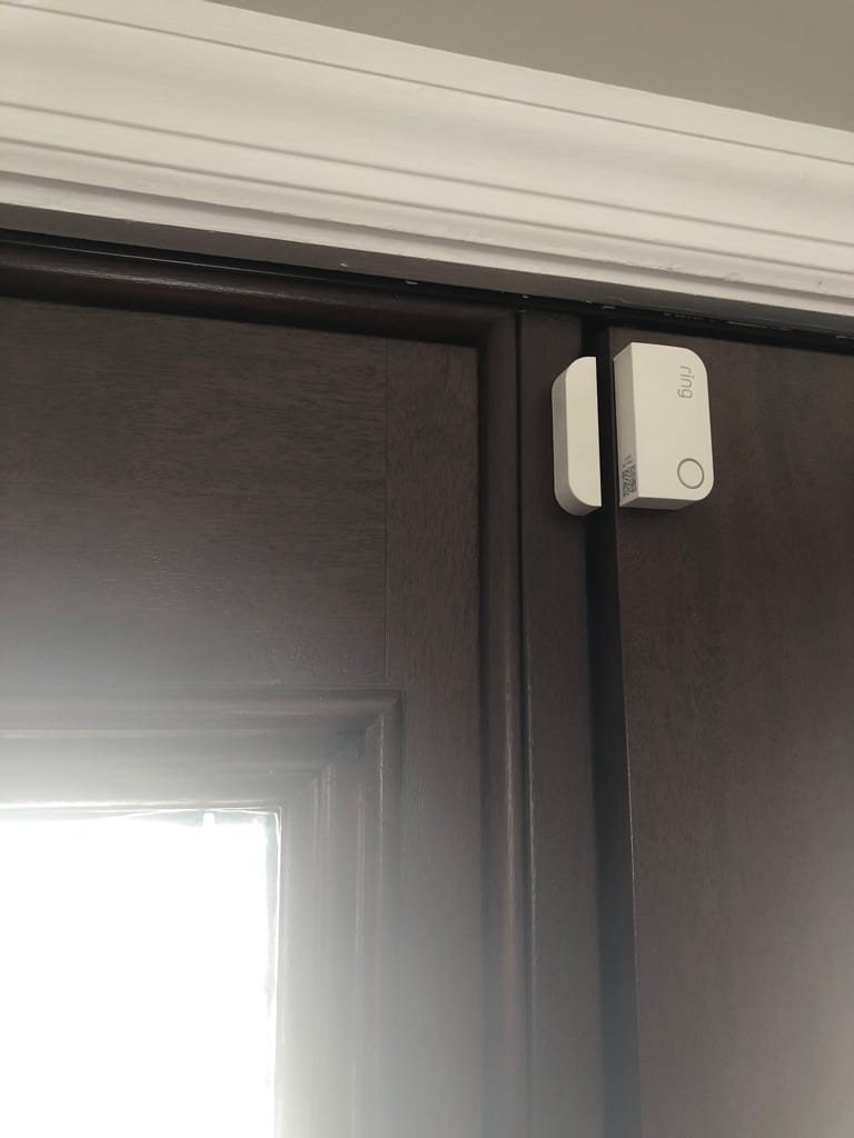 The same complaint on another door: closed and latched, the top latch corner sits out past the frame. UTS ServicePros field photo.